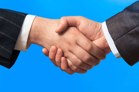 Closeup of a handshake between two business menの写真素材