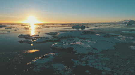 Sunset, ice ocean. Antarctica aerial drone view flight 4k. Epic, fast time lapse overview the sunset...