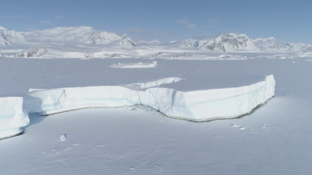 Arctic Polar Frozen Ocean Aerial View. Snow Covered Antarctica Landscape. North Nature Coastline...