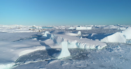 Polar Iceland winter landscape aerial panorama. Frozen ocean, glaciers, icebergs, blue sky in sunny...