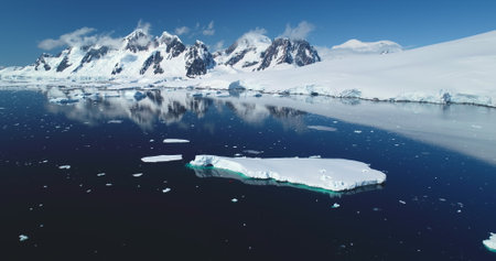 Antarctica snow covered mountain winter landscape. Glacier floating polar frozen ocean, blue sky...