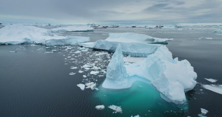 Drifting icebergs in Arctic winter landscape. Antarctica melting blue water glacier. Environment...