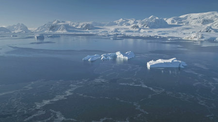 Polar Ocean on Snow Mountains Background. Antarctica Aerial Drone View Flight. Overwhelming Scene of...