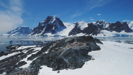 Antarctica Mountain Continent Scenery Aerial View. Majestic Arctic Ocean Snow Island Panorama Global Warming Concept. Epic Cold Polar Landscape Overview Drone Flightの写真素材