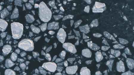 Antarctica ocean brash ice water. Zoom out top down aerial view. Flight in Antarctic melting ice...