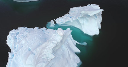Melting icebergs drifting arctic ocean aerial view close up drone panorama. Environment ecological...