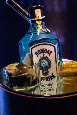 AMSTERDAM, THE NETHERLANDS - July 27 2018 - Bombay Gin in a bucket of ice with lime and lemon on the side in the Netherlandsのeditorial素材