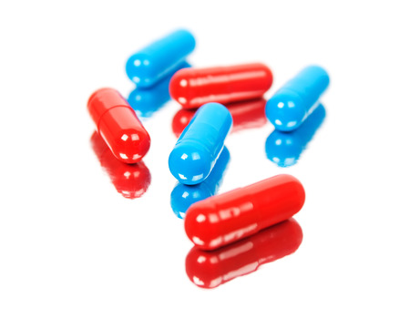 Red and blue tablets. Isolated on white