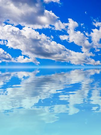 Scenery background - clouds in blue sky reflection in waterの写真素材