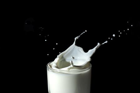 Abstract milk splash against black backgroundの写真素材