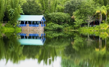 Reflections on a small lake from wooden structures.の写真素材