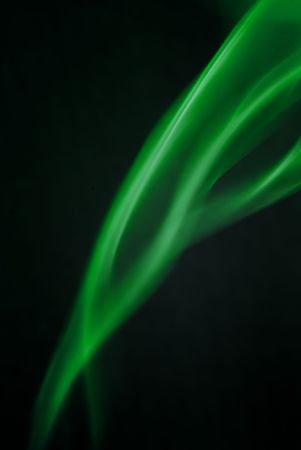 Green smoke waves against a black backgroundの写真素材