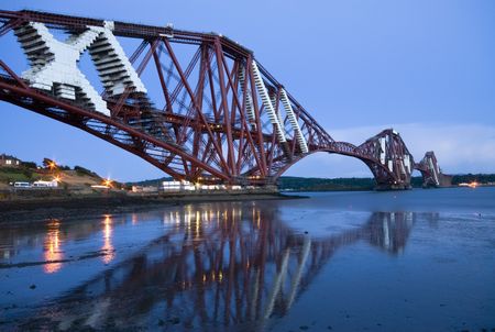 The world-famous Forth Rail Bridge at sunset. Repairing works are taking place on the bridgeの写真素材