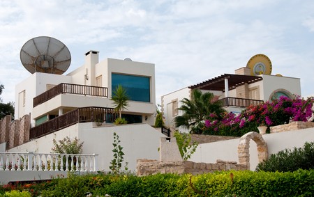 Group of luxury holiday villa houses with nice garden and satellite dishes on the roof. のeditorial素材
