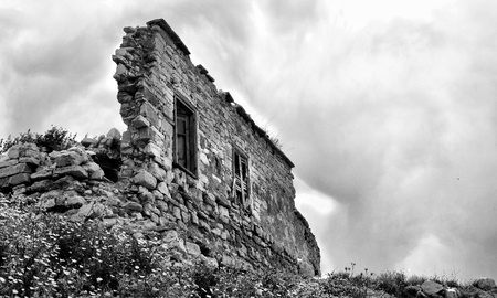 Wall ruins standing against a cloudy sky.の写真素材