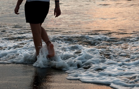 Teenage girl walking on the sandの写真素材