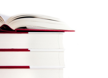Open book on a stack of books isolated on a white backgroundの写真素材