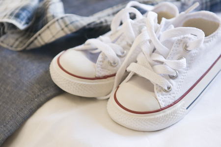 Small baby white shoes for baptism の写真素材