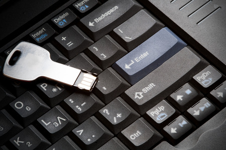 USB memory data stick on a computer Keyboard. Concept of data storage and security.の写真素材