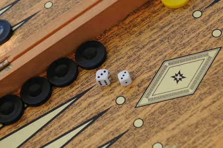 Wooden Backgammon game board with cubes and dices