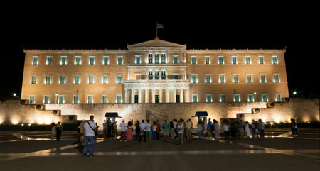 Athens, Greece - August 28, 2014: Tourists in front of the tomb of the unknown soldier in the  parliament building of  Athens, watching the change of the evzone guardsのeditorial素材