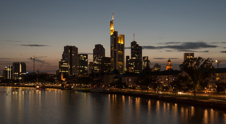 Skyline of financial district of  Frankfurt city in Germany during   twilight with skyscrapers and the river Rhineのeditorial素材