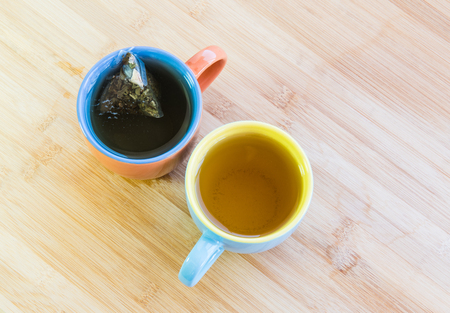 Colorful cups of healthy organic black and green teaの写真素材
