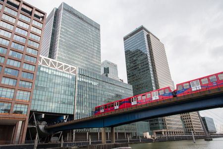 Docklands Light Railway, DLR,  metro  entering the station  located inside the modern skyscrapers at Docklands area in  Canary wharf district, London UK.のeditorial素材