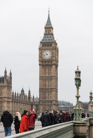 London, England - December 14, 2015: People walking on the Westminster Bridge  in London city near famous Westminster and Big ben clock landmarks of London .のeditorial素材