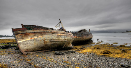 Abandoned wooden fishing boats in the coast of the Isle of Mull in Scotland.の写真素材
