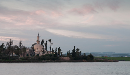 Famous picturesque Hala Sultan Tekke islamic mosque at Larnaka Salt lake in Cyprusの写真素材