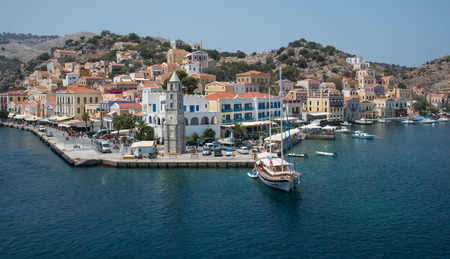 Symi, Greece - August 1 2016: Panoramic image of Symi town with the harbor and the colorful houses...