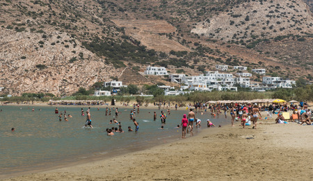 Sifnos, Greece - July 31 2016: Swimmers at Kamares  beach enjoying the summer holidays at the greek island of Sifnos in Greece.のeditorial素材