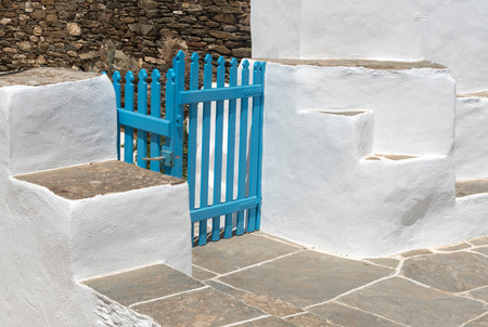Traditional backyard with blue closed wooden rail and white wallsの写真素材