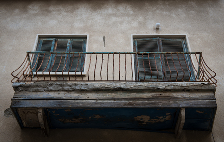 Apartment Balcony with blue wooden doors  in a bad condition ready to collapseの写真素材