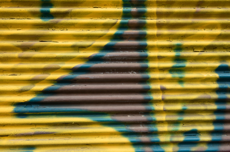 Colourfull metallic graffiti background on a closed metal doorの写真素材