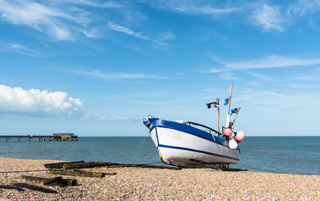 Lonely fishing Boat at the coast and cloudy blue sky.の写真素材