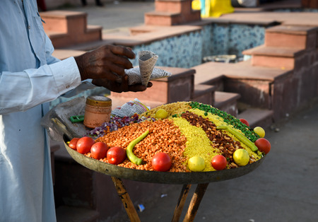Senior man selling spices and vegetables at a fruit market in Jaipur, Rajastan, India.