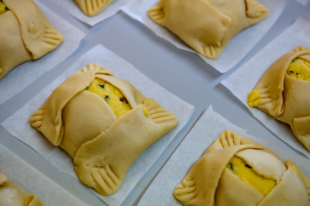 Traditional Cypriot easter cheese pastries ready to be cooked on a clay oven. The easter pastries are called flaounes and are made with various cheese.の写真素材