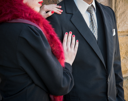 Young teenage woman with hands on manâ€™s arm and chest showing faith to love