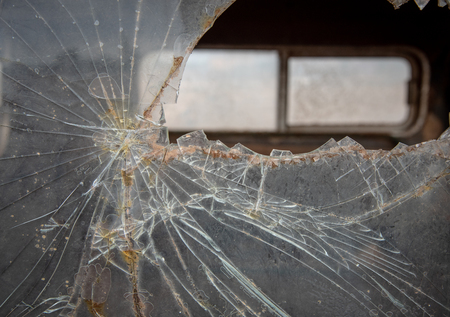 Broken window glass of an abandoned car