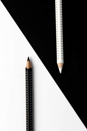 Two wooden drawing pencils on a black and white surface.の写真素材