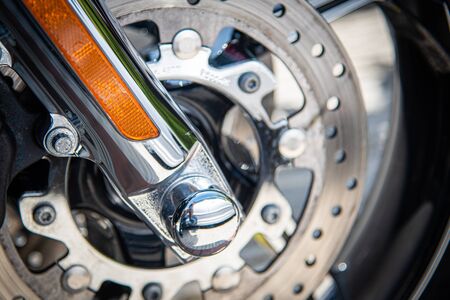 Details of a shiny chrome metal wheel of a sport motorbike
