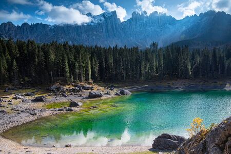 Lake Carezza or Karersee lake with deep blue colored water and the dolomite mountain range Trentino Alto Adige Region, Italy, Europe.の写真素材