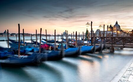 Venice Gondolas moored at the San Marco square or Piazza san Marco,  and the San Giorgio Maggiore island at the back.の写真素材