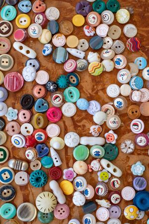 Group of retro colorful fashion sewing buttons on a board