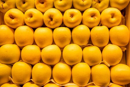 Stack of healthy fresh apple fruits on a fruit marketの写真素材