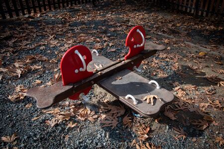 Empty seesaws children park toys on an amusement park in autumn.の写真素材