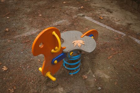 Empty seesaws children park toys on an amusement park in autumn.