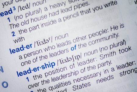 Close-up of the definition of the dictionary word leader and leadership